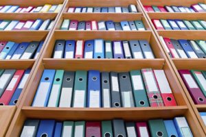 file folders, standing on the shelves in the background