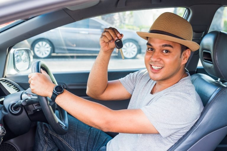 Man holding out car keys