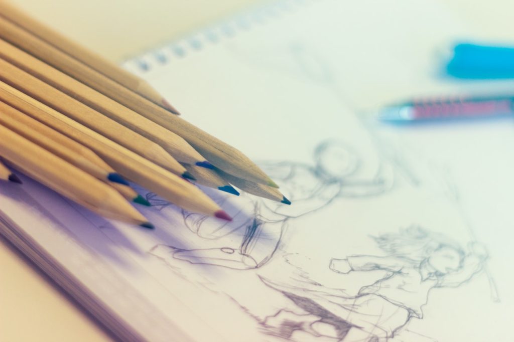 person sketching characters