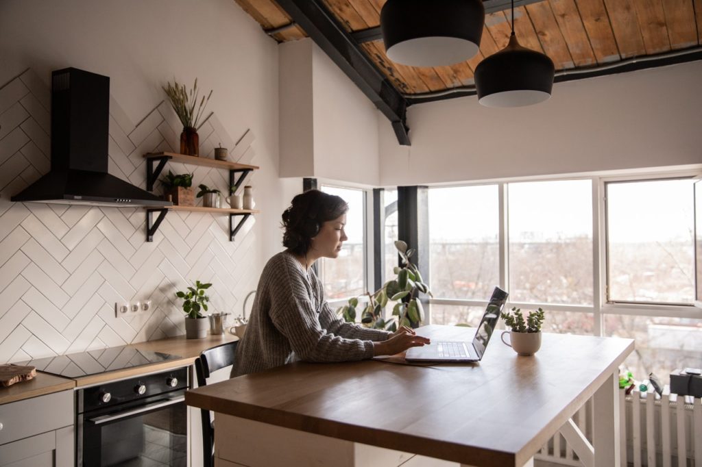 woman working remotely at her kitchen
