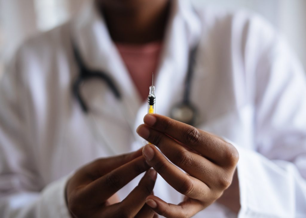 doctor holding a syringe