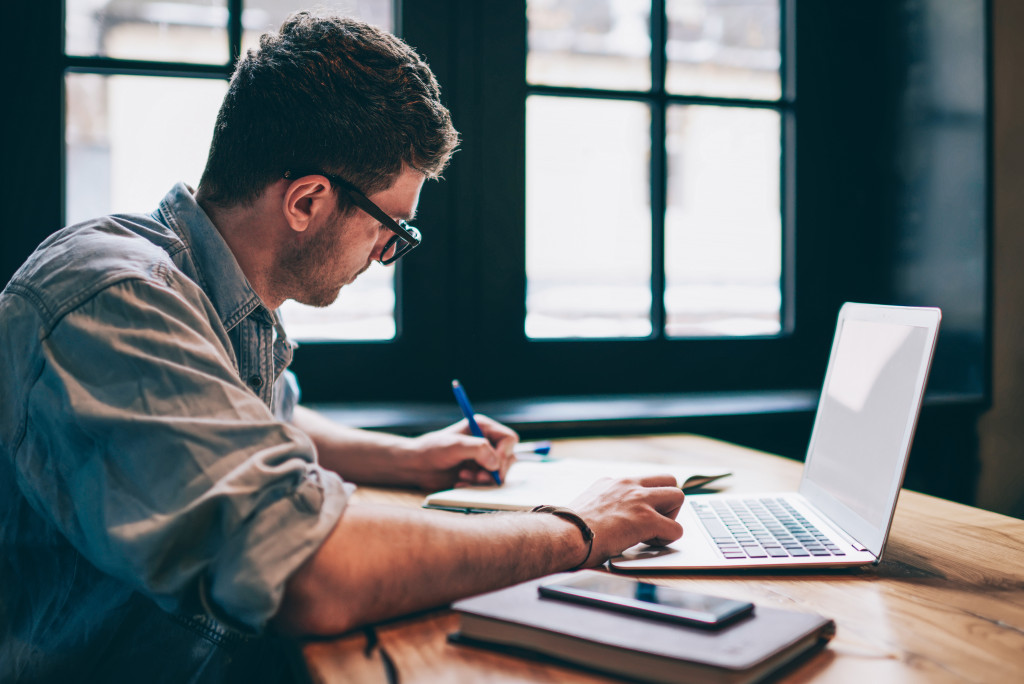 remote worker using his laptop while working at home