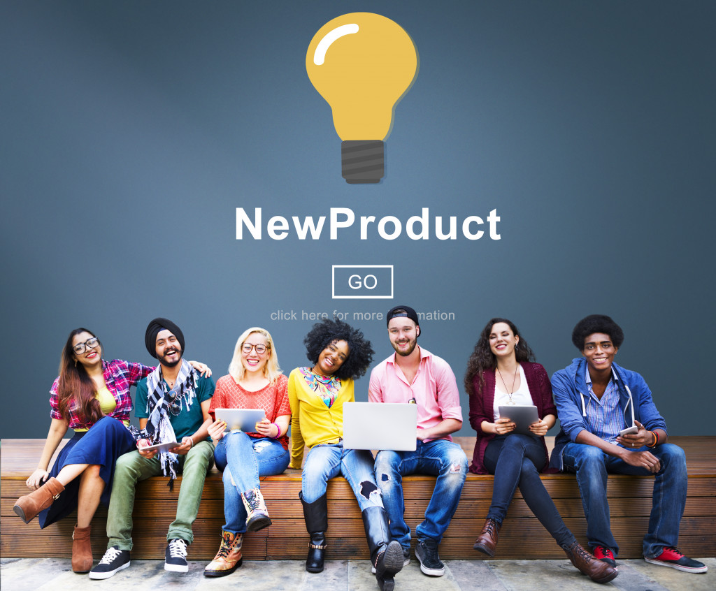 Group of students sitting while new product written above them