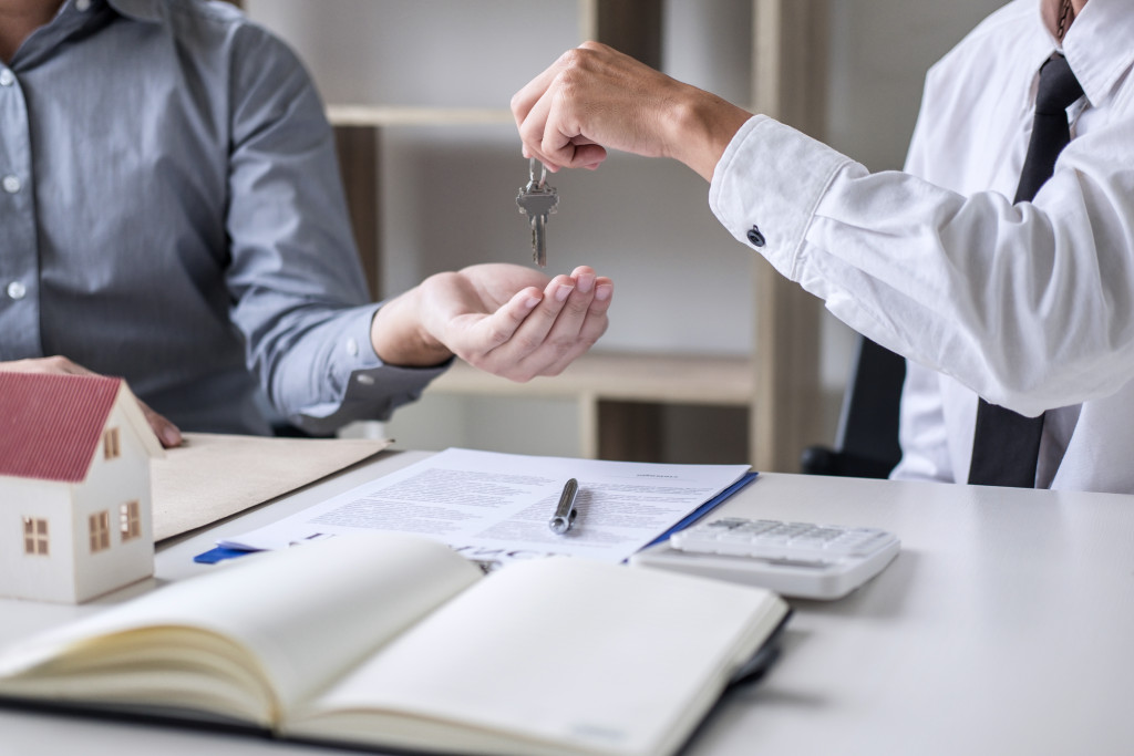 handing out key to a property