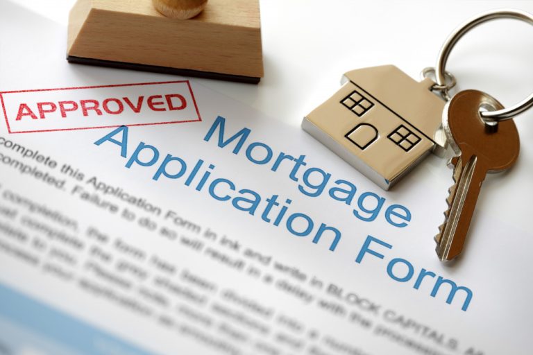 An approved mortgage application form and a house key