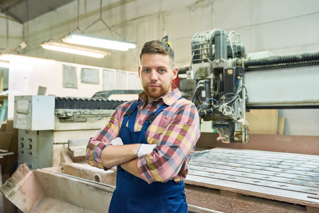 engraving business owner standing in front of the machine