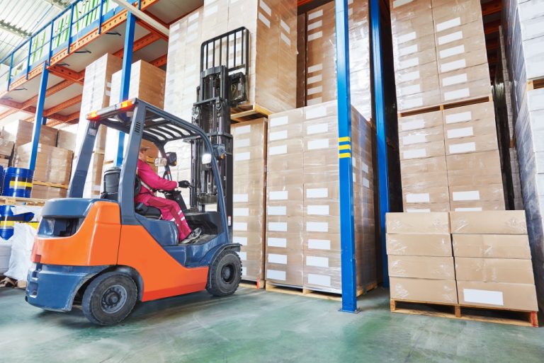 machine lifting boxes in the warehouse