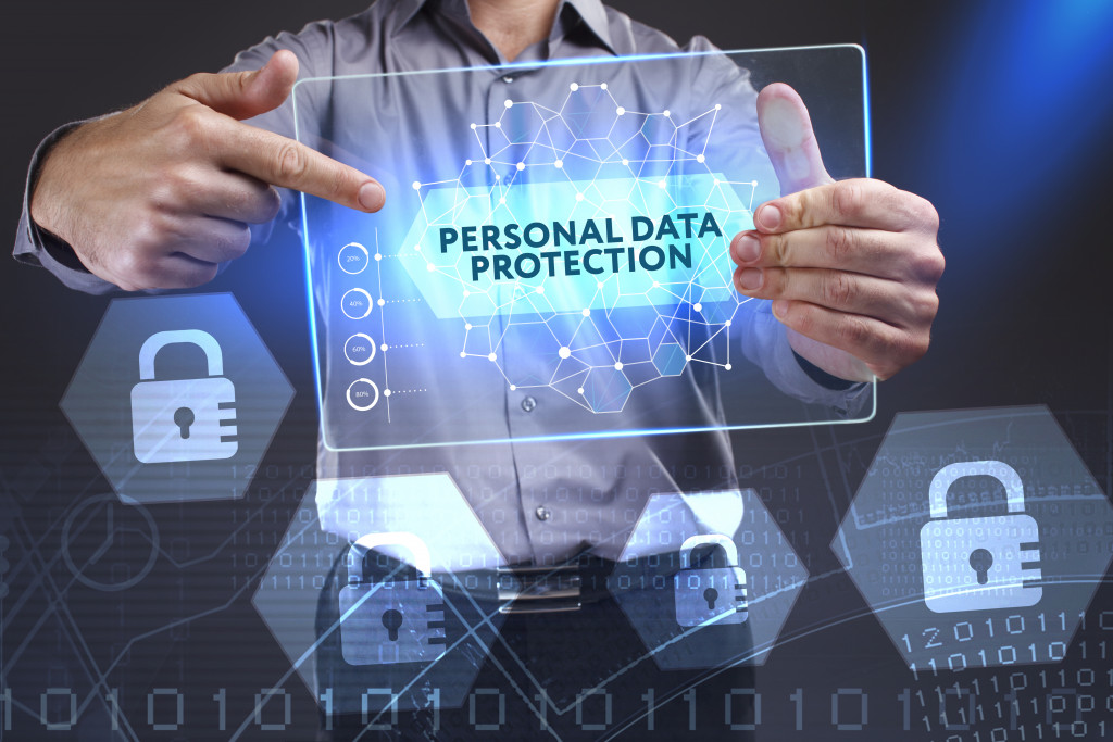 man holding digital data security on a mdoern tablet