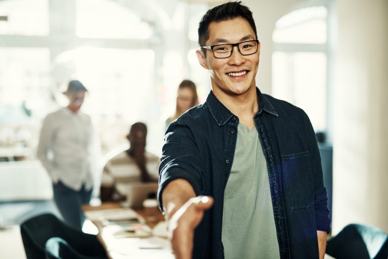 young entrepreneur extending handshake