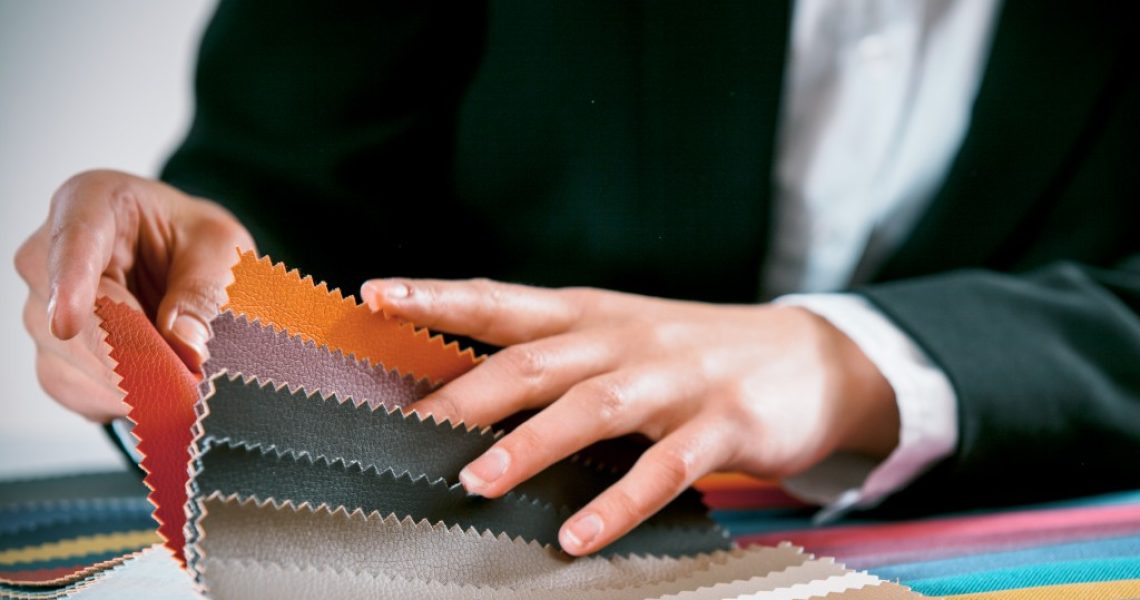 businessperson holding swatches of leathers