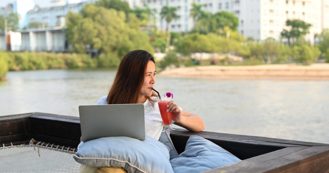 woman on vacation using her laptop