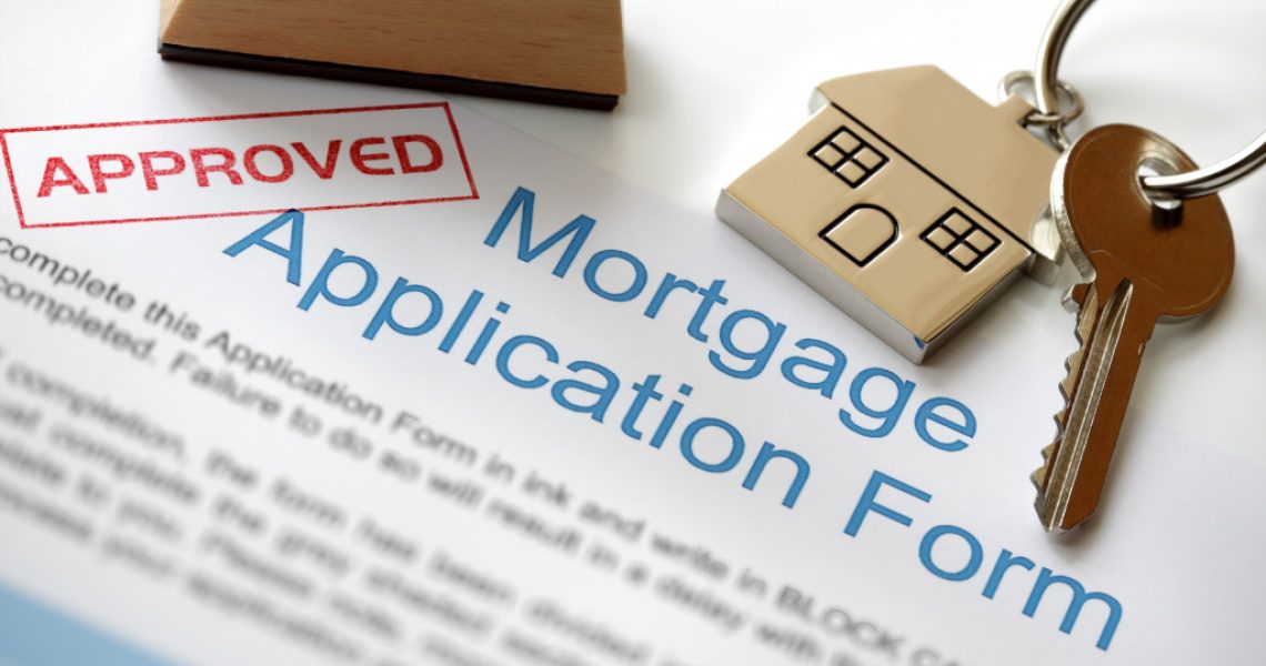 An approved mortgage application form and a house key