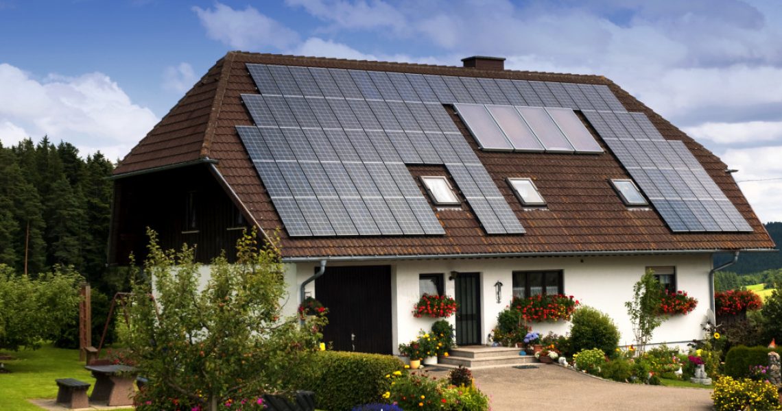 a house with solar panels and greenery